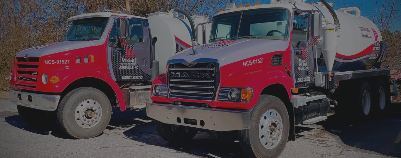 Two septic tank cleaning trucks